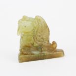 An interesting Chinese carved jade figure of a mythical bird on a triangular base, H. 4cm.