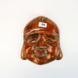 A Chinese carved wooden mask of Putai, H. 25cm.
