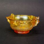 A Chinese relief decorated Peking amber glass bowl, W. 13cm. H. 6cm.
