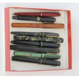 A group of mixed vintage fountain pens, some with gold nibs.