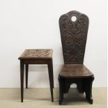 A small 1920's carved oak chair, H. 85cm, together with a carved oak table.
