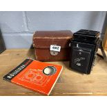 A cased Rolleiking twin lens reflex camera with instructions.