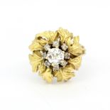 A heavy and large yellow and white metal (tested minimum 9ct gold) flower shaped diamond set cluster