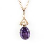 A rose metal pendant set with a large oval cut amethyst, stone size 1.7 x 1.2cm, on a 9ct yellow