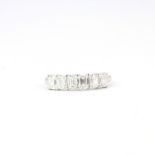 An 18ct white gold half eternity ring set with baguette cut diamonds, 1.5ct overall, (O).