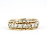 A 9ct yellow and silver set full eternity ring set with white stones, (o). One stone missing.