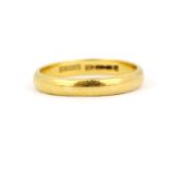 A hallmarked 22ct yellow gold wedding band, (M).