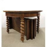 A 1920's circular oak barley twist legged dining table, dia. 122cm, with two extension leaves.