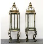 A pair of large bronzed metal and glass storm lanterns, H. 83cm.