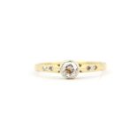 An 18ct yellow gold ring set with an old brilliant cut Diamond with diamond set shoulders, (K).