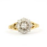 An 18ct yellow and white gold (worn hallmark) diamond set cluster ring, (O.5).