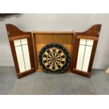 A dart board and cabinet.