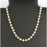 A cultured pearl necklace with a yellow metal (tested 9ct gold) clasp, L. 40cm.