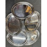 Six large stainless steel serving trays, W. 60cm.