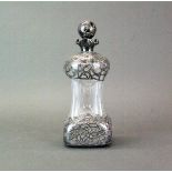 An ornate silver overlaid liquor decanter, H. 24cm. (stamped sterling).