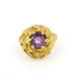 A heavy 14ct yellow gold (approx. marked 569) ring set with a round cut amethyst, (O). Slight bend