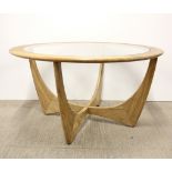 A 1970's circular coffee table with plate glass top, dia. 84cm.