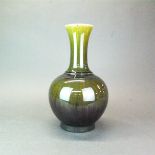 An unusual Chinese olive green and red glazed porcelain vase, H. 34cm. Six character mark to base