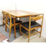 A G-plan style 1970's teak extending dining table and six mixed chairs.