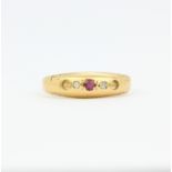 An 18ct yellow gold ruby and diamond ring, (N.5). Two stones missing.