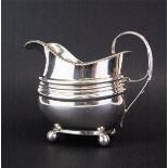 A Georgian hallmarked silver cream jug, H. 11cm.