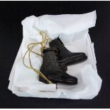 A pair of antique miniature handmade leather boots, H. 5.5cm. L. 5cm.