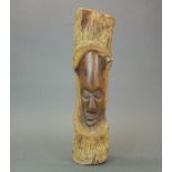 An African carved hardwood tree trunk mask, H. 41cm.