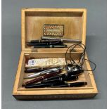 An Eastern inlaid box with pen contents.