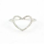 An 18ct white gold heart ring set with brilliant cut diamonds, (N).