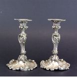 A pair of 19th Century rococo silver plated candlesticks, probably Elkington. H. 11cm.