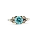 An 18ct and platinum ring set with a blue spinel and white topaz, (J).