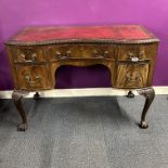 A 20th C leather topped mahogany writing desk with carved ball and claw feet, 107 x 77cm.