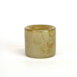 A Chinese carved mutton fat jade thumb ring, W. 3.5cm. Dia. 4cm.