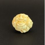 A Japanese carved and signed bone kabuki mask ball, Dia. 4cm.