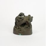 A Chinese bronze weight decorated with a Qilin and tortoise, H. 5cm.