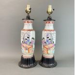 A pair of mid-20th Century Chinese hand enamelled porcelain vases later mounted on wooden bases as