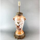 A 19th Century Japanese porcelain vase mounted circa 1920 with a metal base and top frame as a table