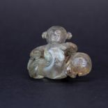 A Chinese glass crystal figure of a boy with a young dragon, W. 5cm, H. 3.5cm.
