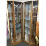 A Pair of glass shelved corner display cabinets with mirrored interiors, H. 177cm.