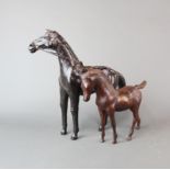 A handmade leather model of a horse together with a bronze model of a foal, tallest H. 33cm,