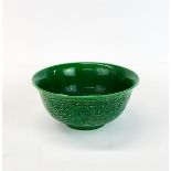 A Chinese relief decorated and green glazed porcelain rice bowl, Dia. 15.5cm. H. 7cm.