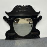 A black finished, carved hardwood over mantle mirror, 107 x 95cm.