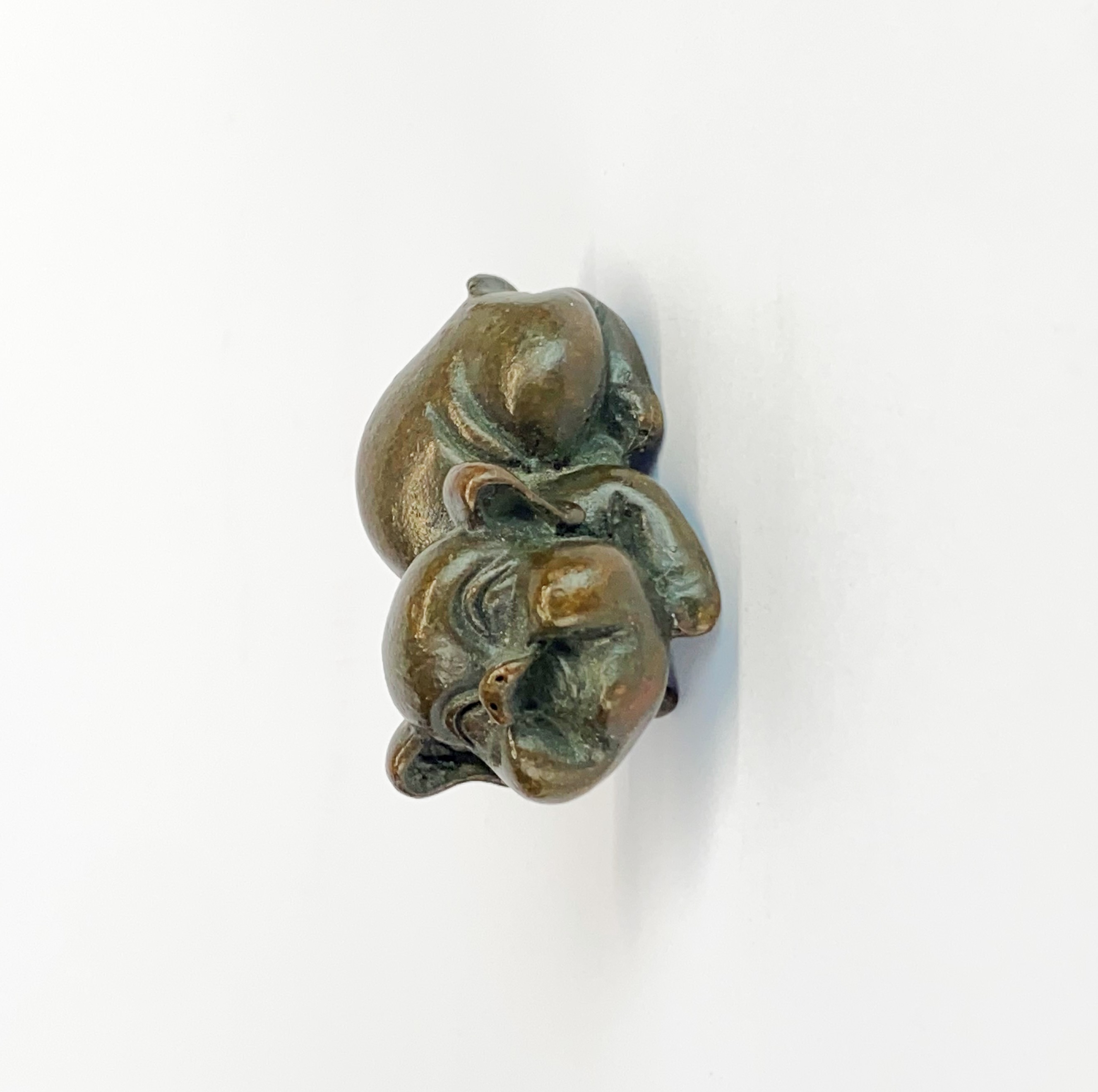 A small oriental bronze figure of a laughing pig, L. 5cm.