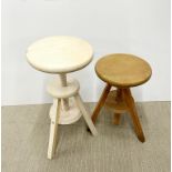 A pair of adjustable milking stools, tallest H. 60cm.