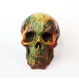 A cast resin skull incorporating various other elements, H. 14cm.
