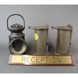A railway signalling lamp, two further railway items and a reception desk sign.