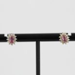 A pair of 9ct yellow and white gold cluster stud earrings set with an oval cut pink sapphire