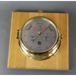 An S.E.Wills ship's style wall mounted barometer, matching lot 322, mount size 25 x 25cm.