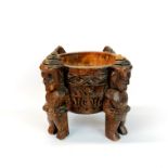 A Polynesian carved wooden offering bowl supported by four male figures, Dia. 24cm. H. 19cm.