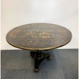 An early 19th Century chinoiserie tilt top low table on single column with lions paw feet, Dia.